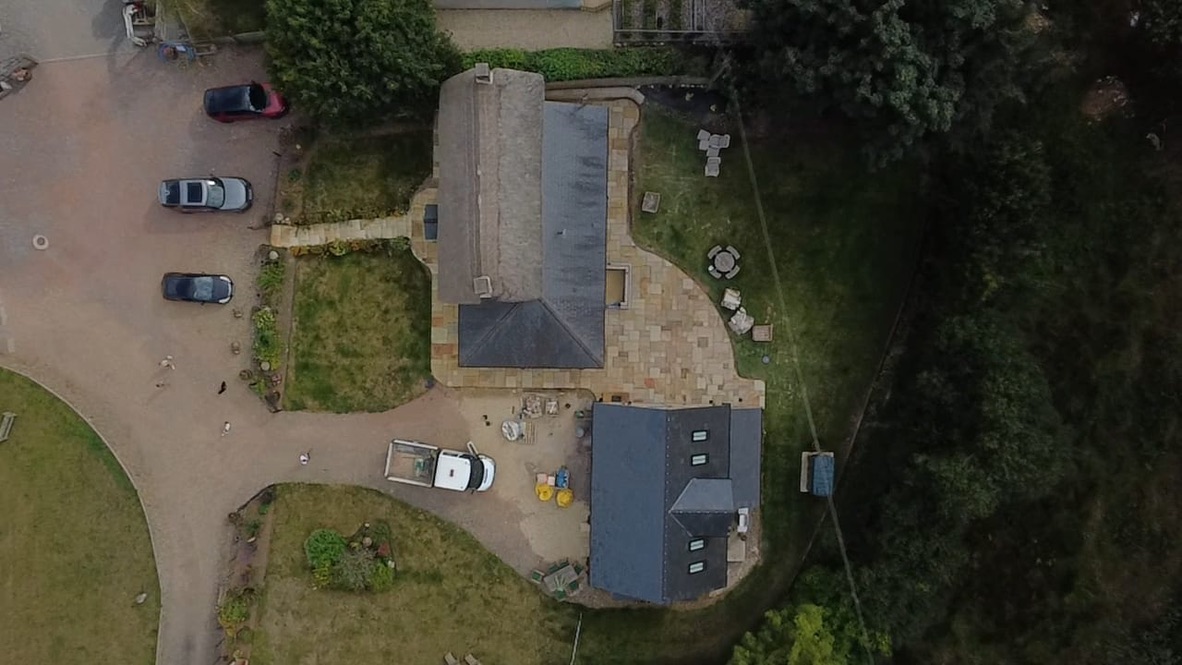 Aerial view of the property showing the new paving, gravel driveway and parking area