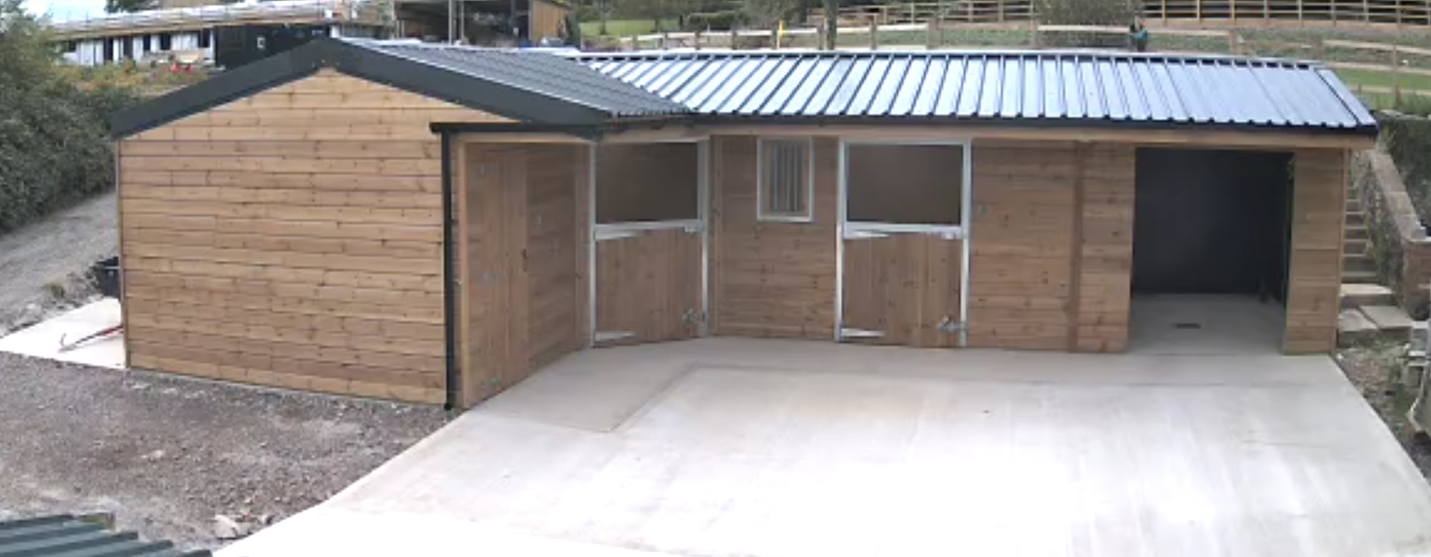 Timber stable block with a steel roof and concrete hardstanding built by O Farley Building & Maintenance