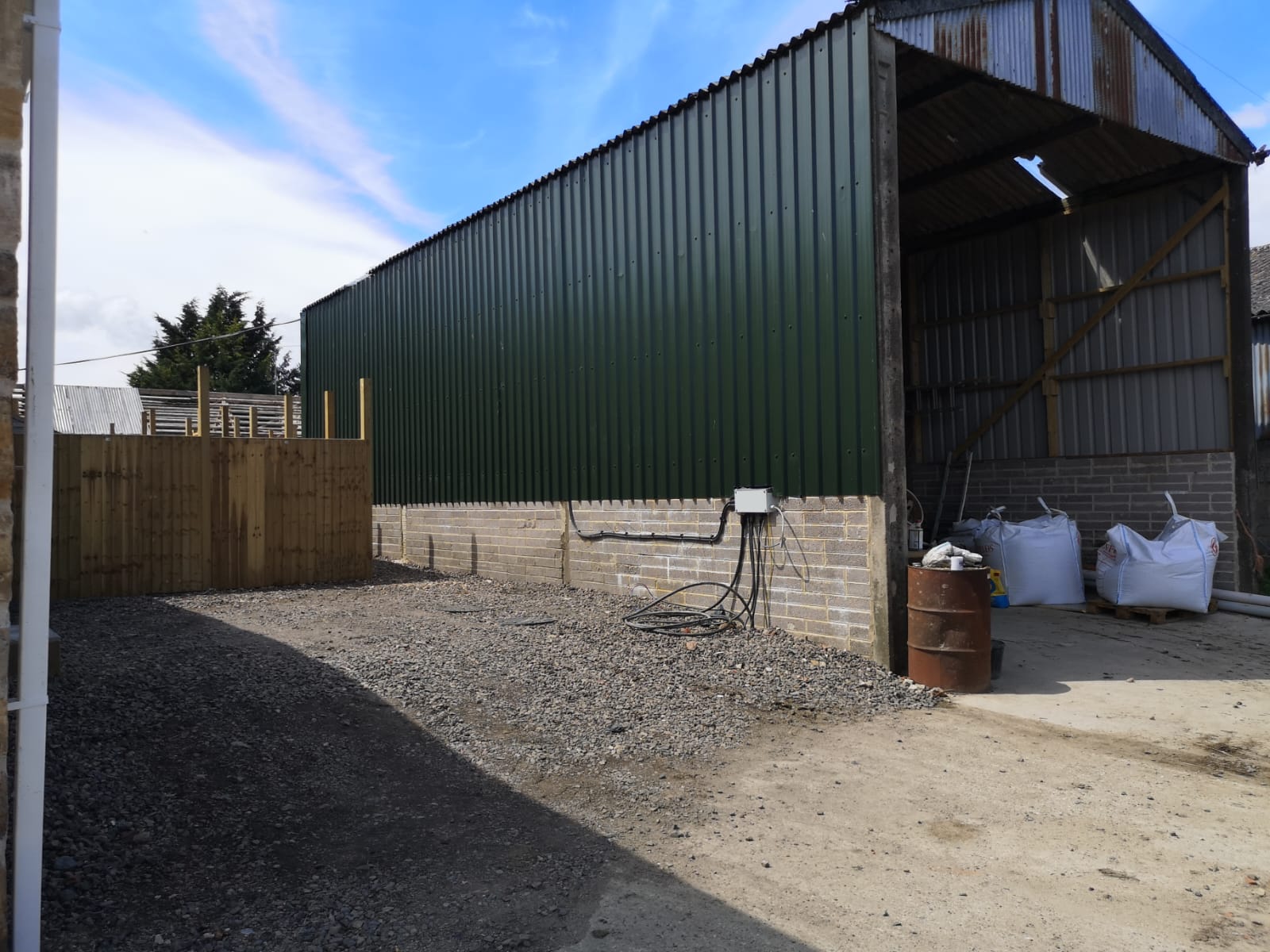 A completed agricultural building clad in green steel sheeting