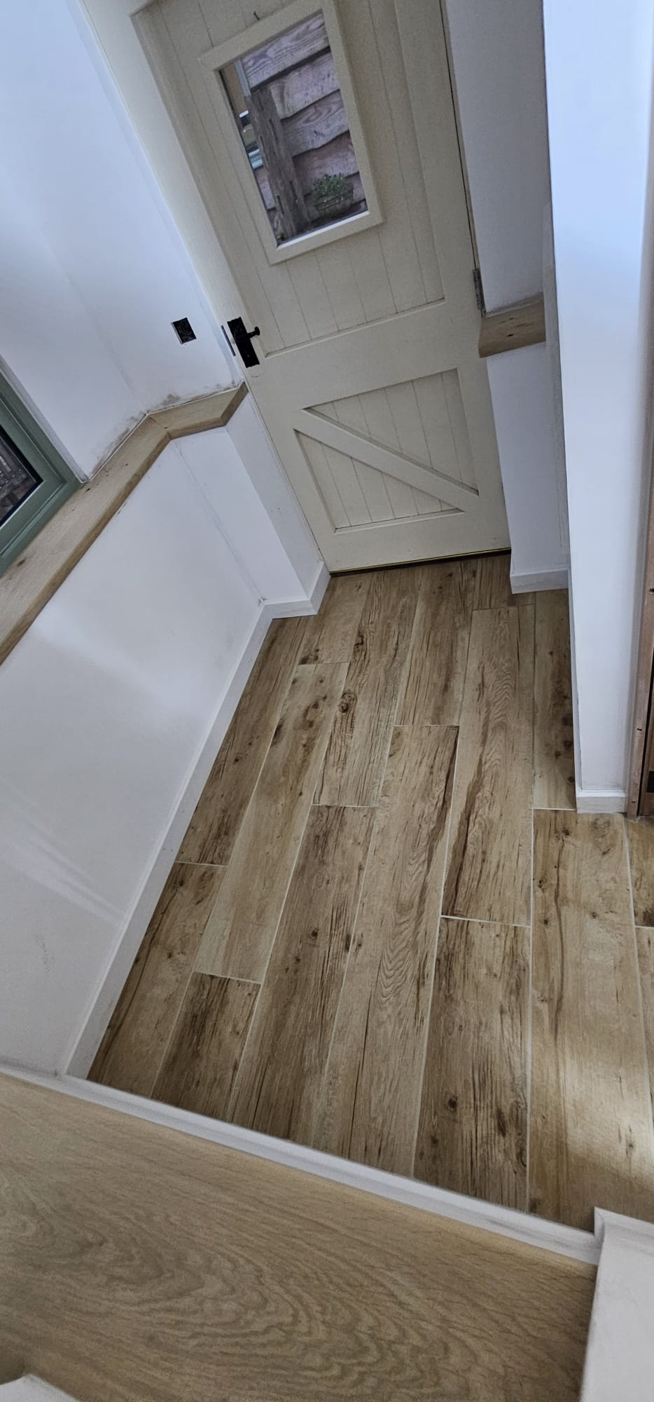 The hallway beyond the new porch with oak-effect flooring
